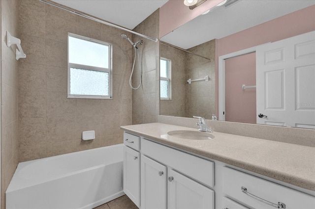 bathroom with vanity, tile patterned floors, and tiled shower / bath