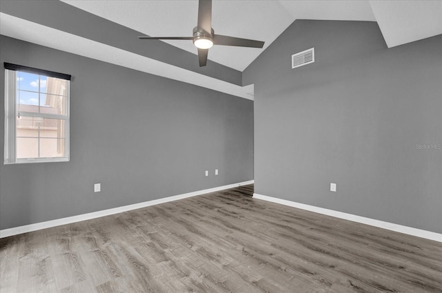 spare room with wood-type flooring, ceiling fan, and vaulted ceiling