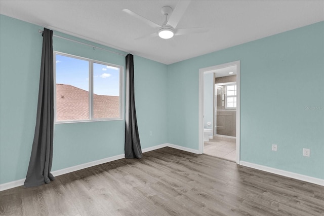 spare room with wood-type flooring and ceiling fan