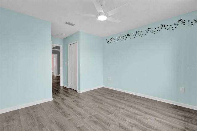 spare room featuring ceiling fan and light hardwood / wood-style flooring