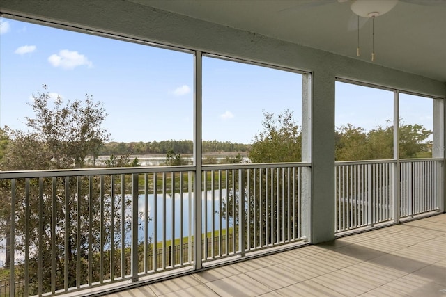 unfurnished sunroom with a healthy amount of sunlight and a water view