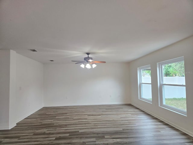 unfurnished room with hardwood / wood-style flooring and ceiling fan