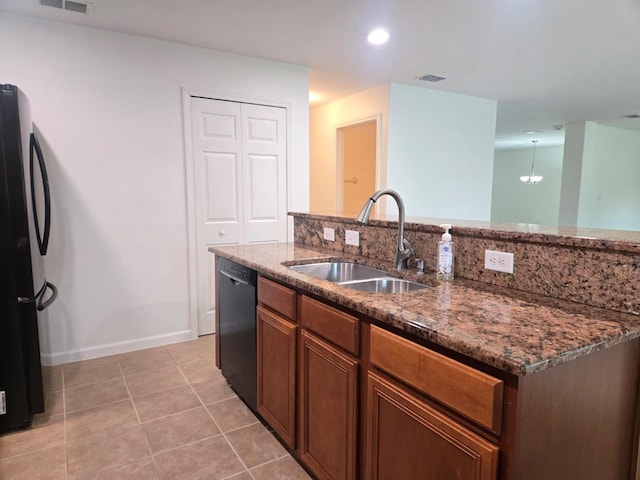 kitchen featuring sink, light tile patterned floors, an inviting chandelier, black appliances, and dark stone counters