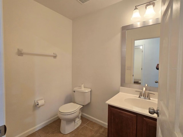 bathroom with vanity, tile patterned floors, and toilet