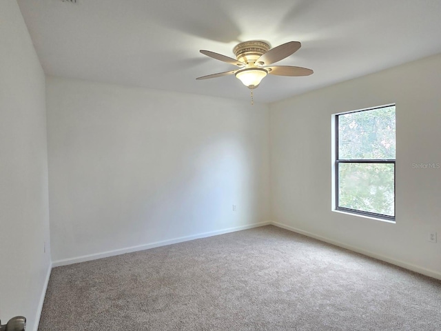 spare room with carpet floors and ceiling fan