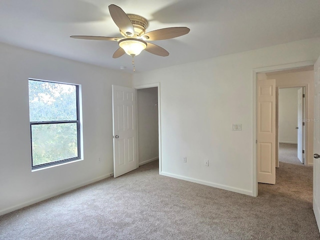 spare room with light colored carpet and ceiling fan