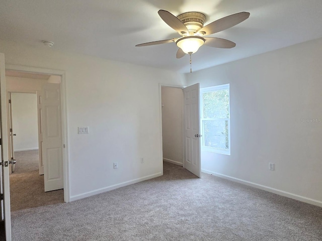 carpeted empty room with ceiling fan