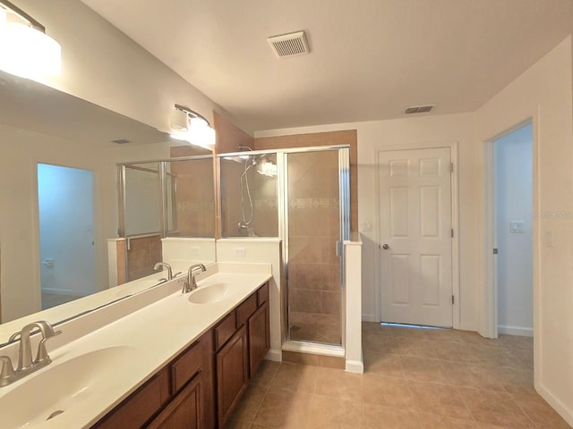 bathroom with vanity, tile patterned floors, and a shower with shower door