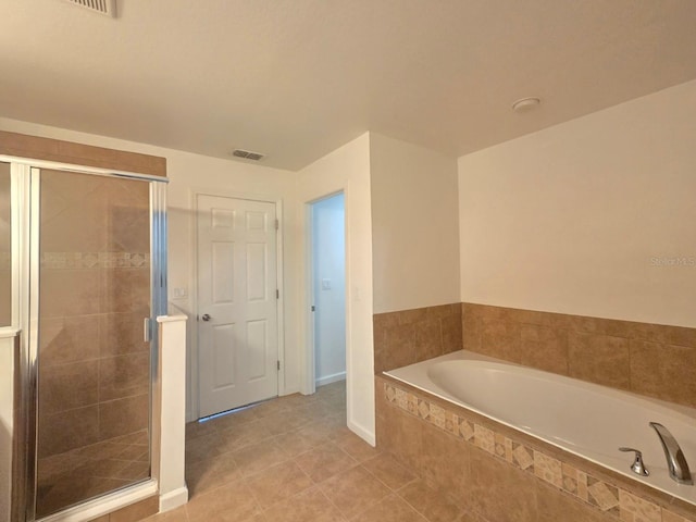 bathroom with separate shower and tub and tile patterned floors