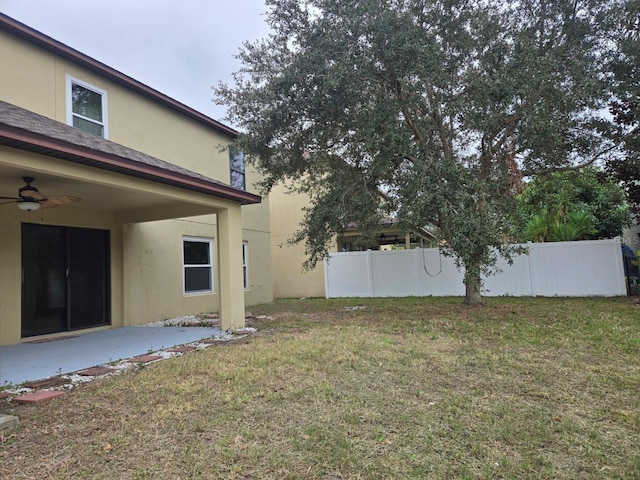 view of yard with a patio and ceiling fan