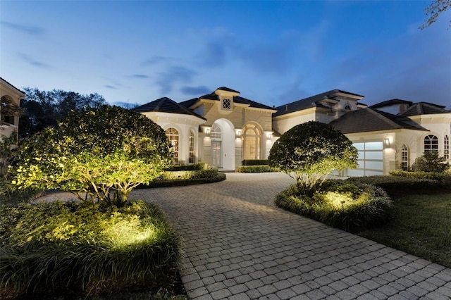 mediterranean / spanish-style house with a garage