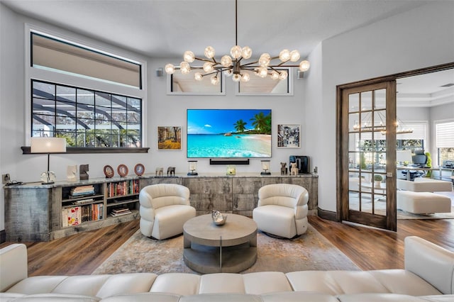 living room featuring an inviting chandelier and hardwood / wood-style flooring