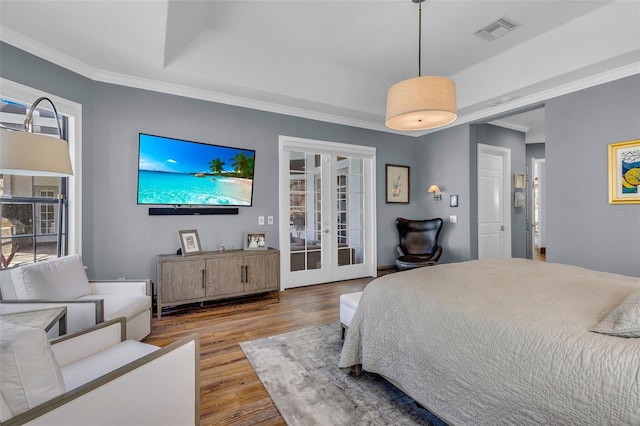 bedroom with crown molding, hardwood / wood-style flooring, access to outside, and french doors