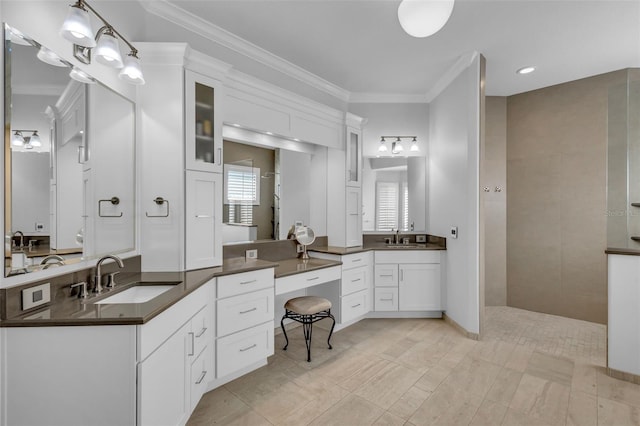 bathroom featuring ornamental molding and vanity