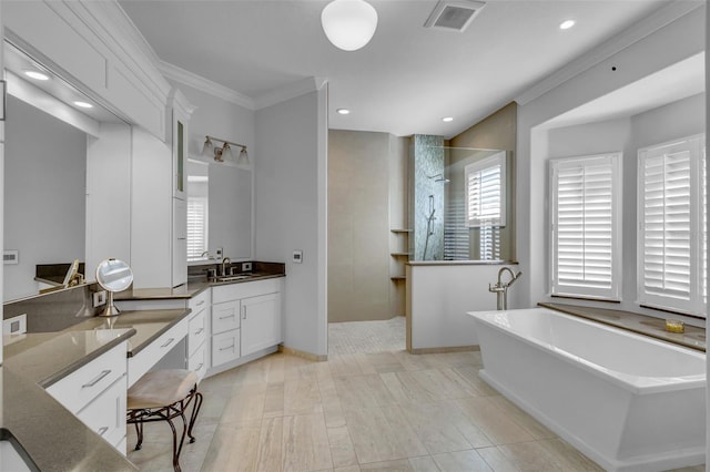 bathroom featuring crown molding, vanity, and shower with separate bathtub