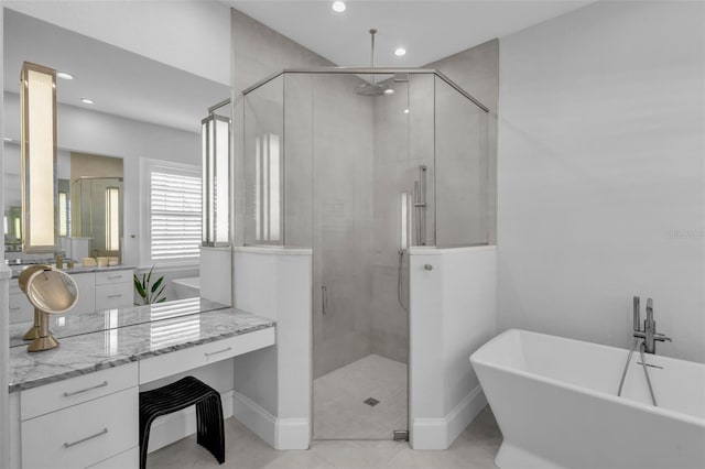 bathroom with vanity and separate shower and tub