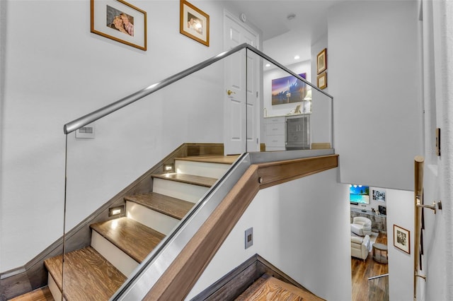 stairs with wood-type flooring