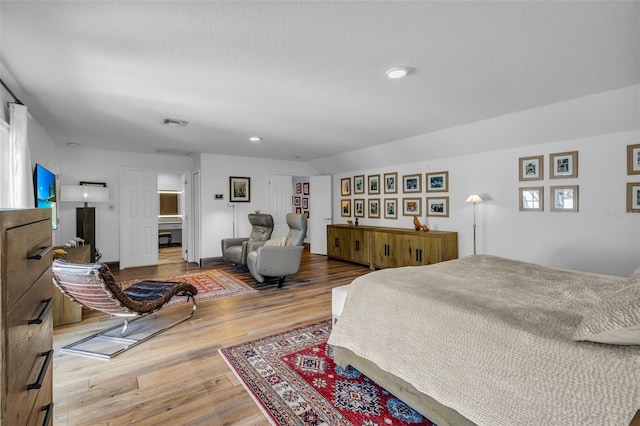 bedroom with hardwood / wood-style floors