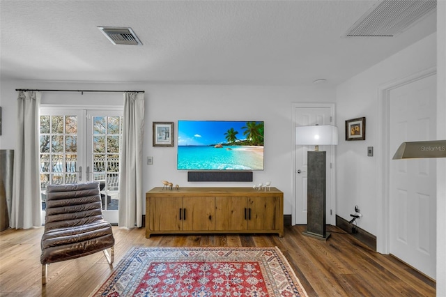 living room with dark hardwood / wood-style floors and a textured ceiling