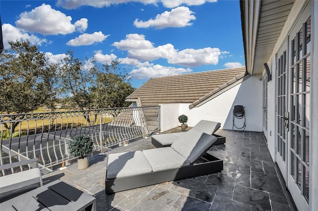 view of patio featuring a balcony