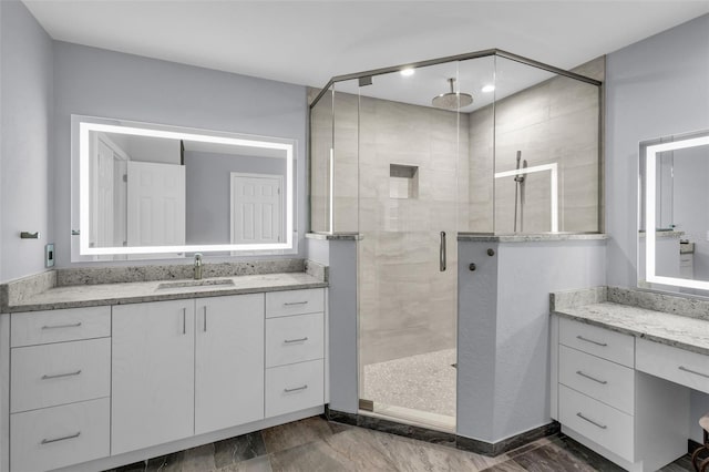 bathroom featuring vanity and an enclosed shower