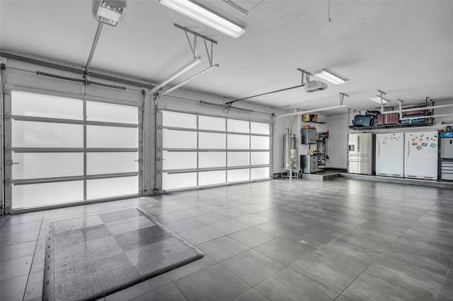 garage featuring water heater and a garage door opener