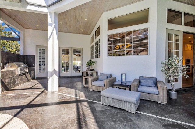 view of patio / terrace with french doors, an outdoor kitchen, and area for grilling