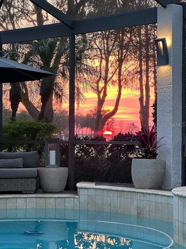 view of pool at dusk