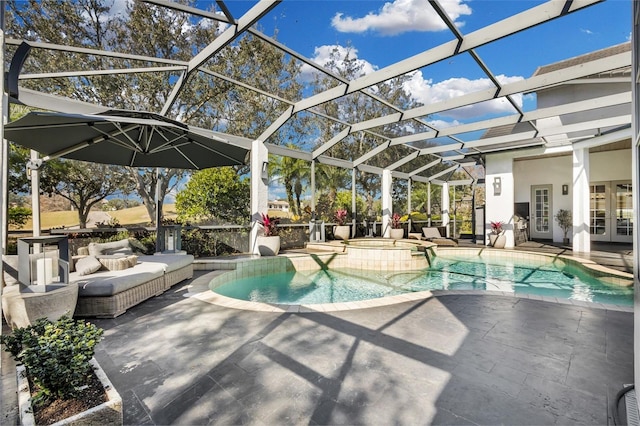 view of swimming pool with a patio area, an in ground hot tub, and glass enclosure