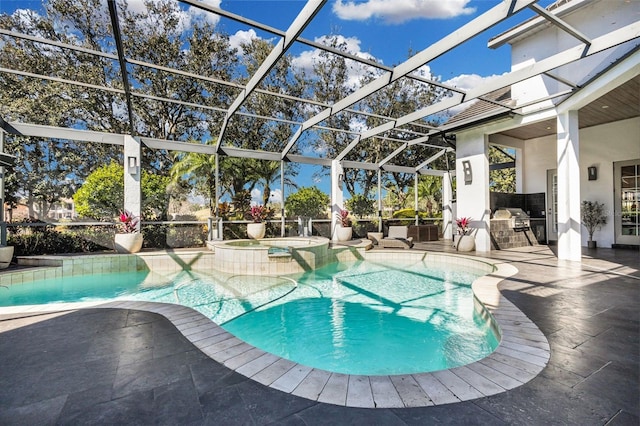 view of swimming pool with a lanai, a patio area, exterior kitchen, and an in ground hot tub