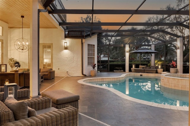 pool at dusk featuring outdoor lounge area, a patio area, and a lanai