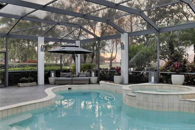 view of pool featuring an in ground hot tub, a lanai, and a patio area