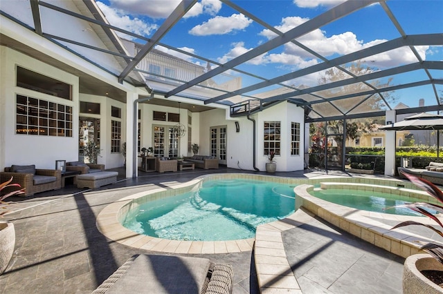 view of pool featuring an in ground hot tub, a patio, outdoor lounge area, and glass enclosure