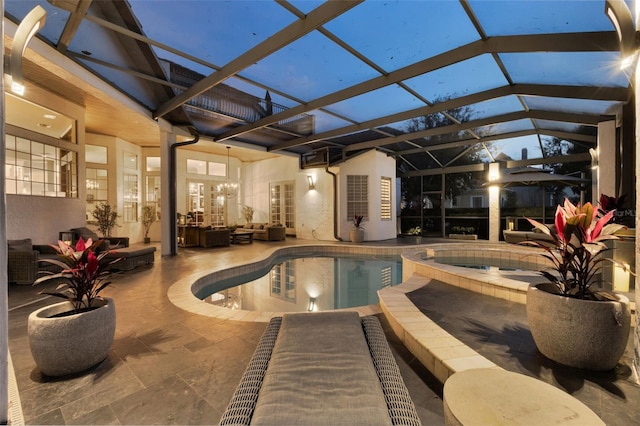 view of pool with an in ground hot tub, a lanai, and a patio area