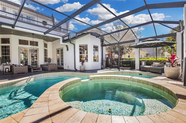 view of pool featuring outdoor lounge area, a patio, glass enclosure, and an in ground hot tub