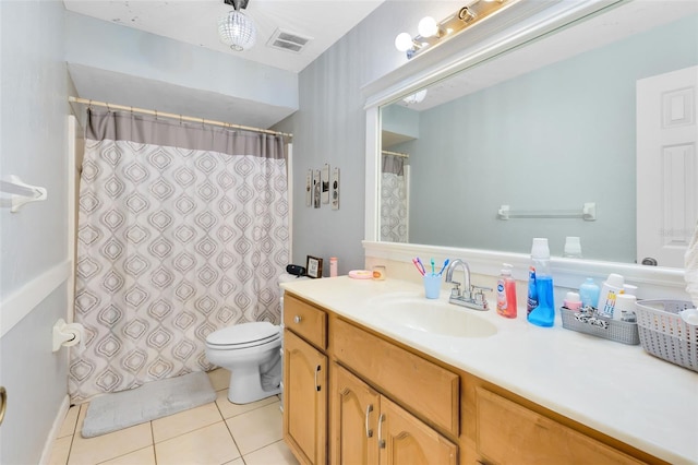 bathroom featuring tile patterned flooring, vanity, and toilet