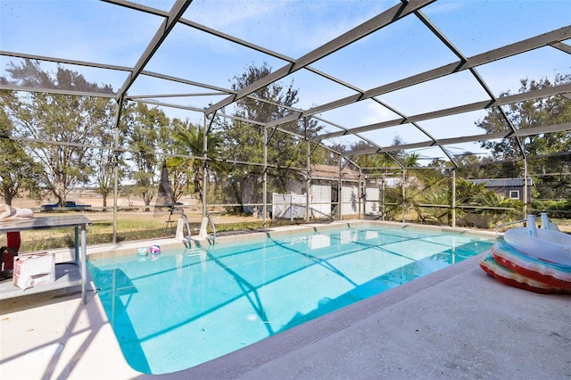 view of swimming pool with a patio and glass enclosure