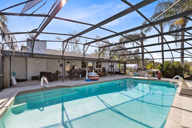 view of pool with outdoor lounge area, a lanai, and a patio area