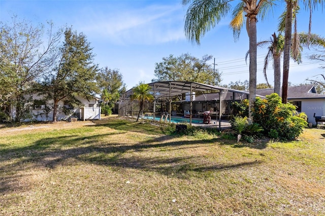 view of yard featuring a fenced in pool and glass enclosure