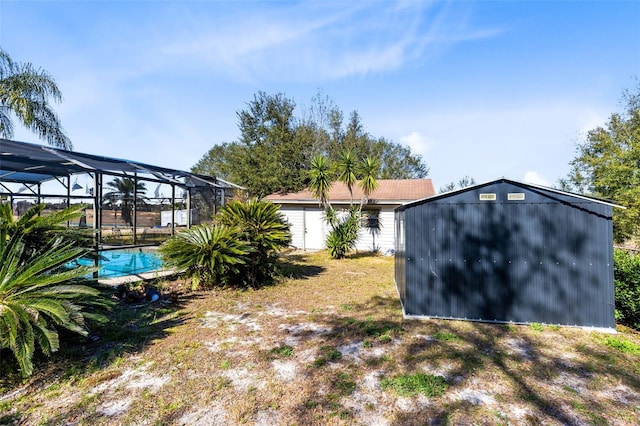 view of yard featuring glass enclosure and a shed