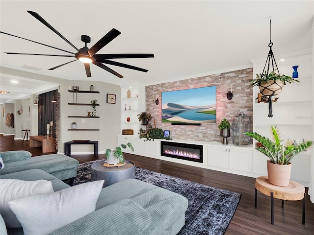 living room with dark wood-type flooring, ornamental molding, and ceiling fan