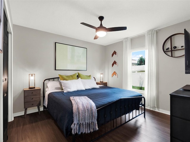 bedroom with ceiling fan and dark hardwood / wood-style floors