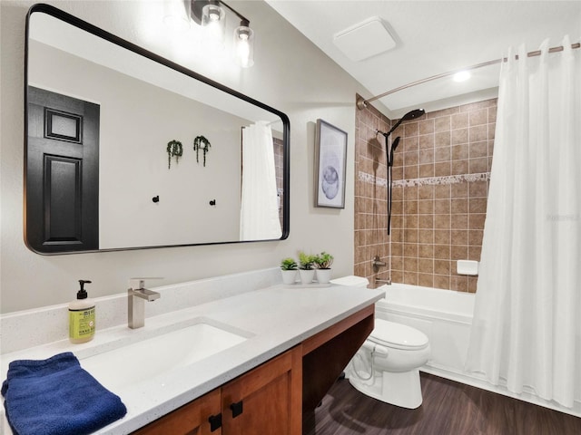 full bathroom featuring vanity, hardwood / wood-style flooring, shower / bath combination with curtain, and toilet