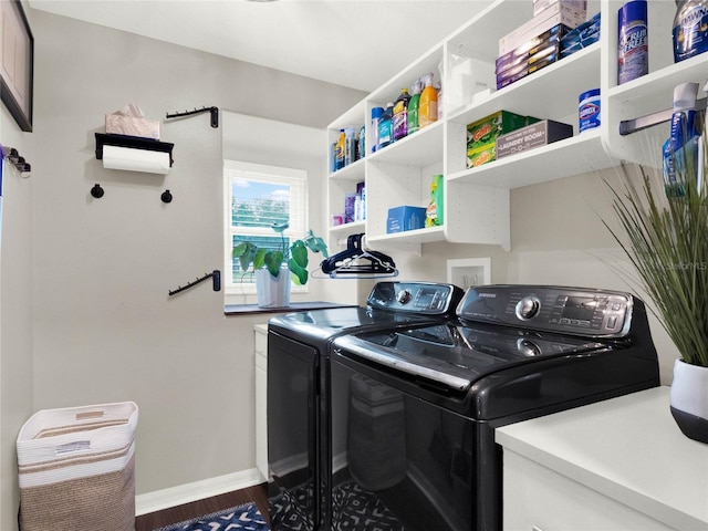 laundry area featuring separate washer and dryer and hardwood / wood-style floors