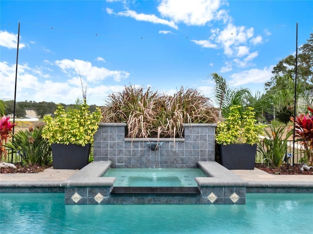 view of pool featuring an in ground hot tub