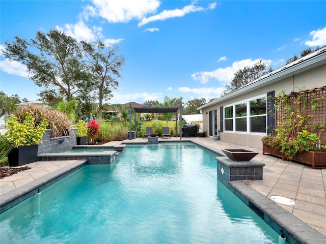 view of swimming pool featuring an in ground hot tub and a patio area