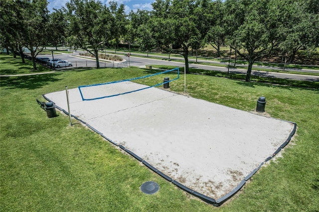 view of property's community featuring a lawn and volleyball court