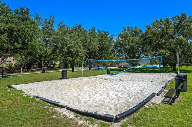 surrounding community with a yard and volleyball court