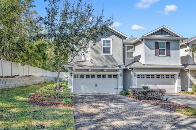 view of front of home featuring a garage and a front lawn