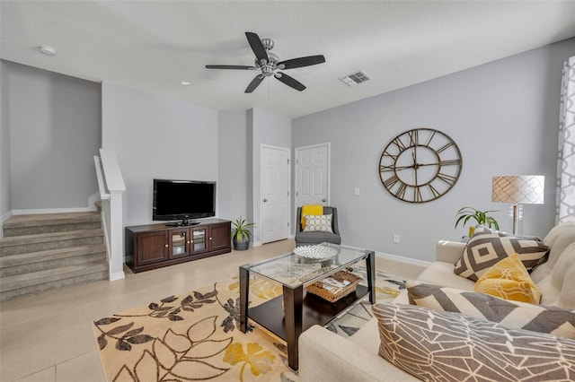 tiled living room with ceiling fan and a textured ceiling